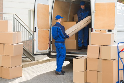 Staff at Stjohnswood Storage handling items safely in a secure facility