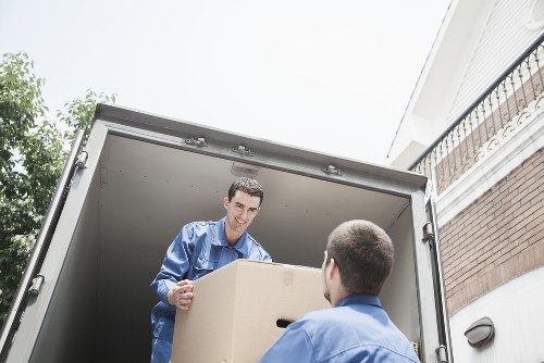 Professional movers transporting furniture in Stjohnswood